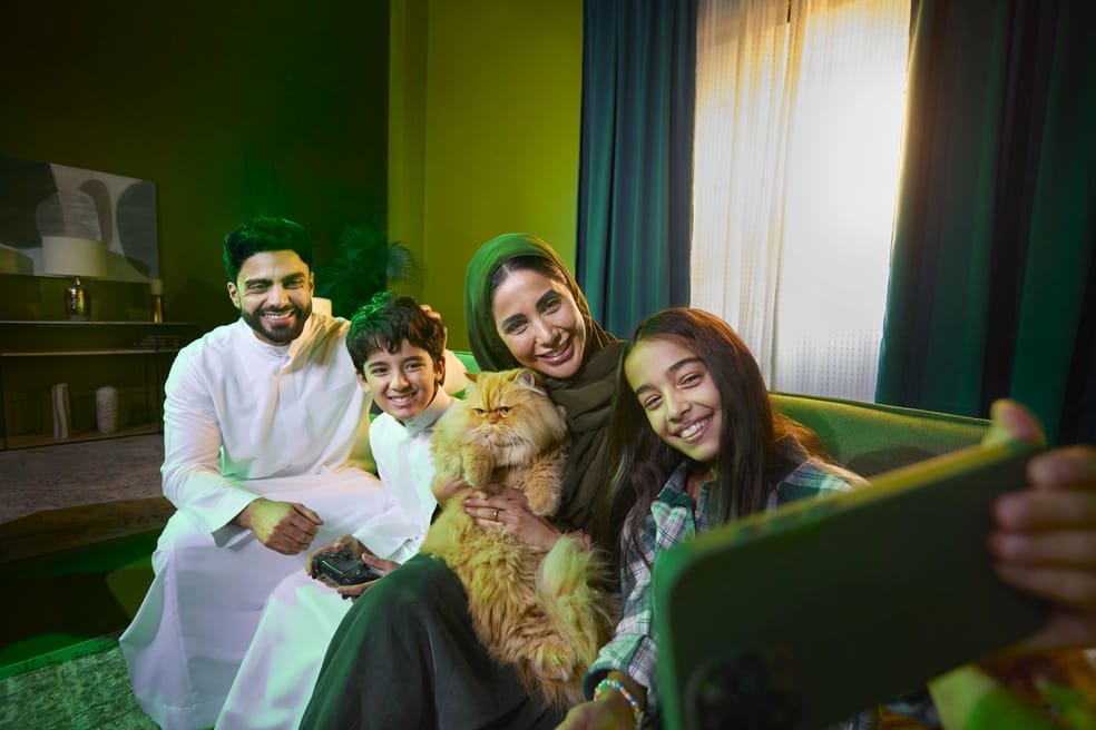 Family taking a selfie together at home on a Salam prepaid data SIM with high-speed internet
