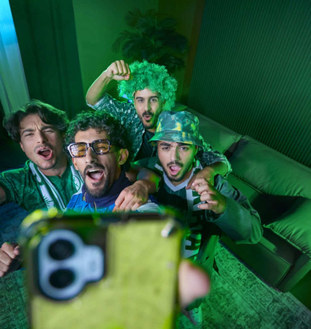 Friends cheering while streaming live sport at home on Salam fibre unlimited home internet