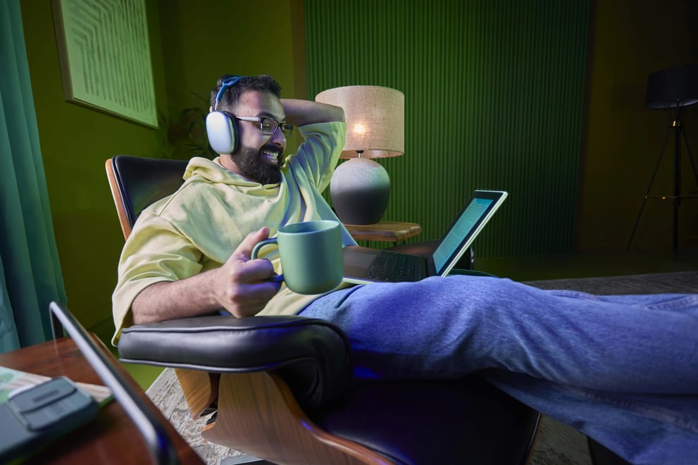 Man having coffee and using a laptop on a Salam roaming data add-on in Saudi Arabia