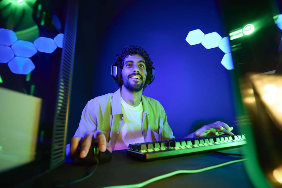 Man gaming online at home using a Salam Boost add-on for faster mobile data in Saudi Arabia